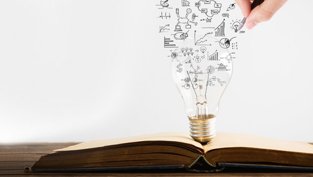 Book and light bulb with hand drawing graph